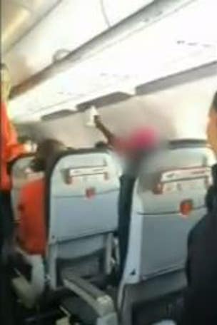 Removed passenger screamed, hit crew with bible