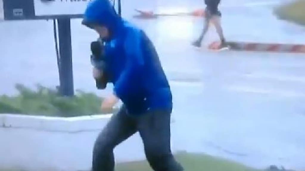 Reporter captured swaying in Florence - as 2 people stroll by behind him