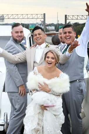 Newlyweds take pictures on highway