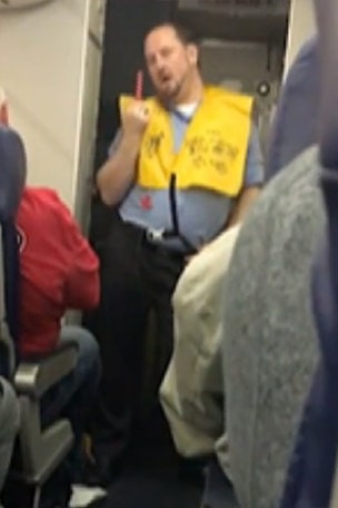 Flight attendant mimes striptease during demo