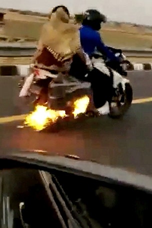Family with child on flaming bike