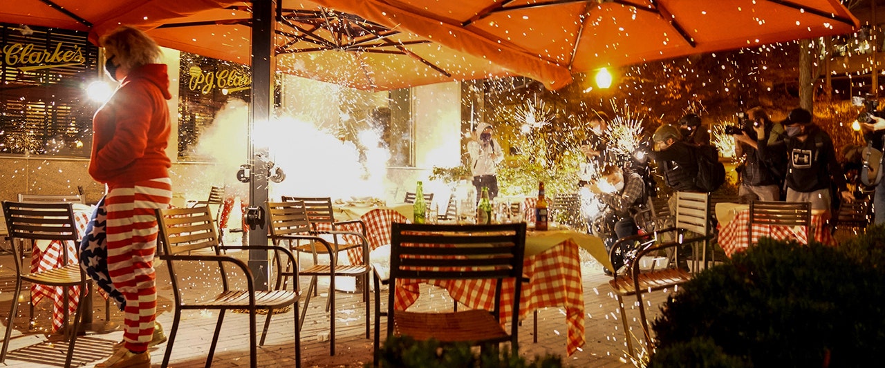 WATCH: Violent rioters throw fireworks at Trump supporters eating dinner after MAGA march