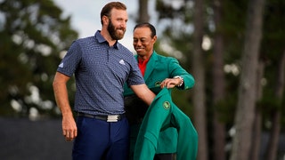 Tiger putting green jacket on Dustin