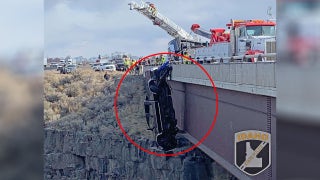 Rescuers save 2 from pickup dangling over deep Idaho gorge