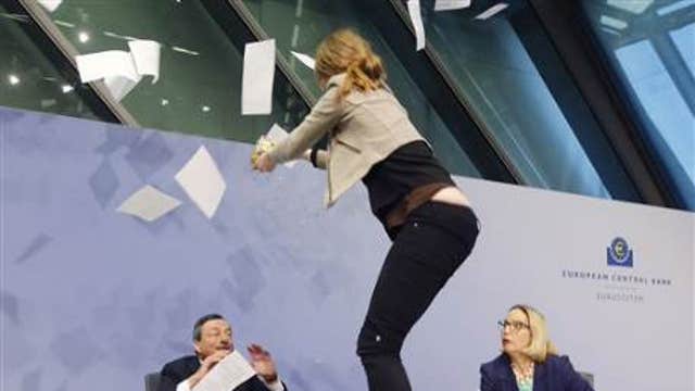 An anti-ECB protester charged the stage during Draghi’s press conference shouting ‘end ECB dictatorship.’
