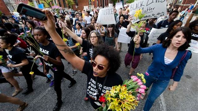 Crowds gather in Baltimore ahead of 10pm curfew