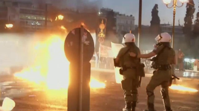 Greek protests turn violent after officials approve bailout plan