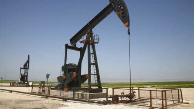 Oil falls, settles below $50 a barrel