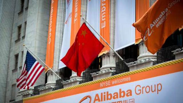 Alibaba begins trading in record-setting IPO