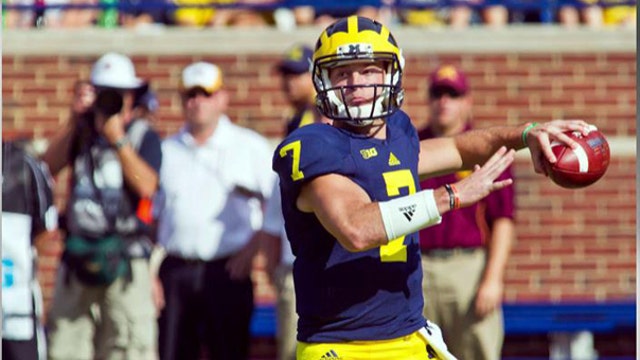Michigan coach under fire for keeping QB in game