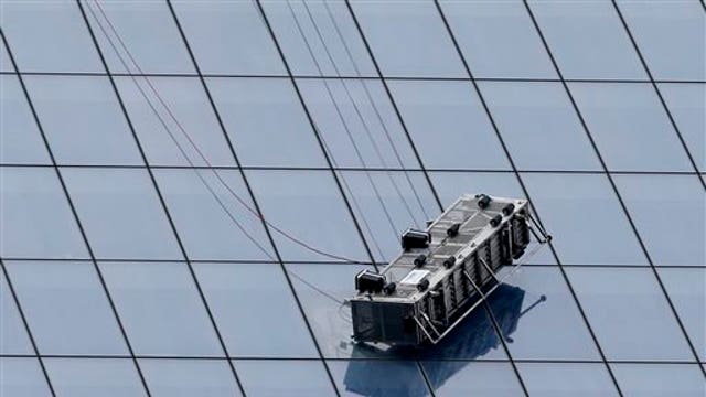 Two workers dangling 69 floors up