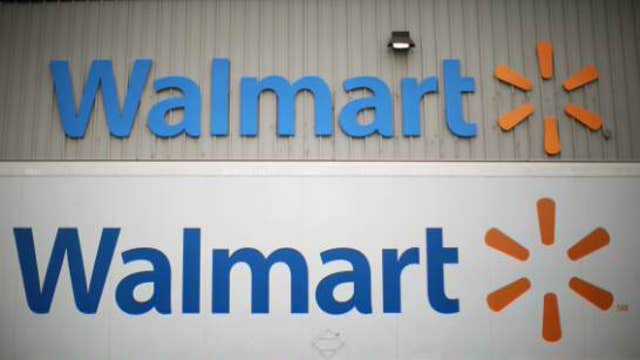 How will Wal-Mart settle the dispute with the NLRB?