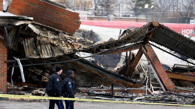 Ferguson business owner surveys damage