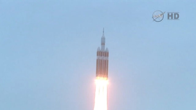 Orion blasts into space