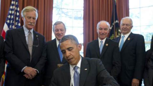 Obama warns GOP he will wield veto pen in 2015