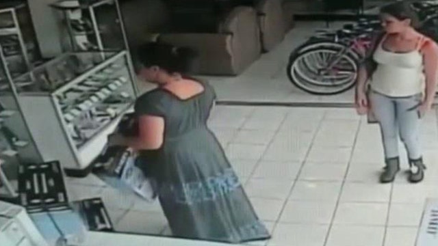 Woman caught on surveillance tape stealing TV under dress