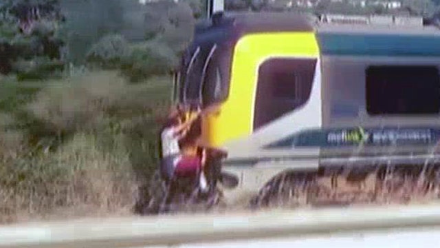 Shocking 'train surfing' stunt caught on camera