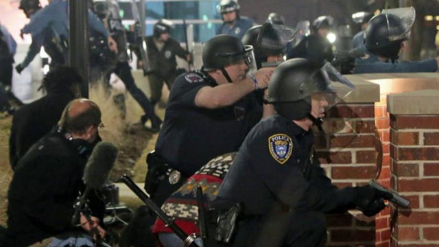 Gunman at large after two officers shot in Ferguson protest