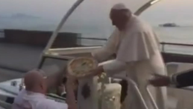 Pope Francis accepts pizza while riding in Popemobile