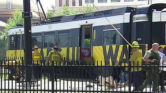 More than 20 injured after commuter train collides into car