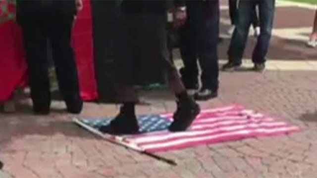 Vet detained after stopping protestors from walking on flag