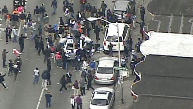 Rioters destroy Baltimore police squad car