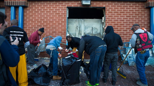 Clean-up begins in Baltimore after night of rioting