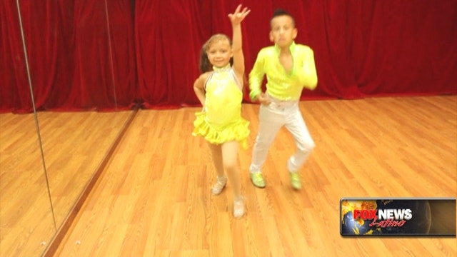 Cute salsa champs give it their all on the dance floor