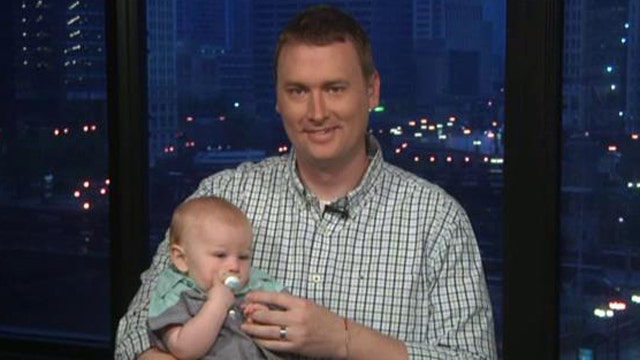 Dad catches foul ball while holding baby