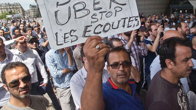 French taxi drivers smash cars in protests against Uber