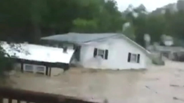 Neighbors watch in horror as floodwaters sweep home away