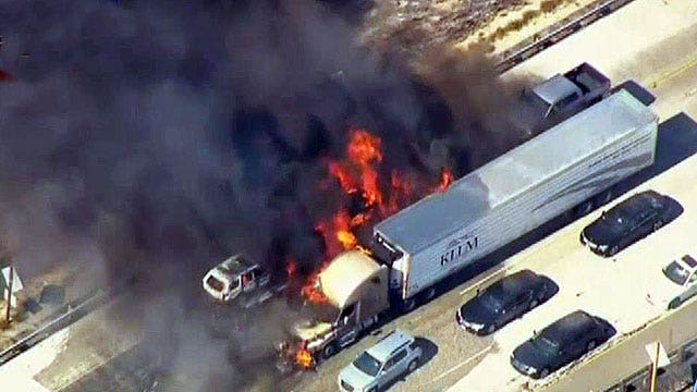 Brush fire engulfs California highway, sets cars ablaze