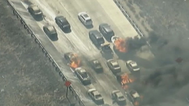 Wildfire sweeps across California freeway