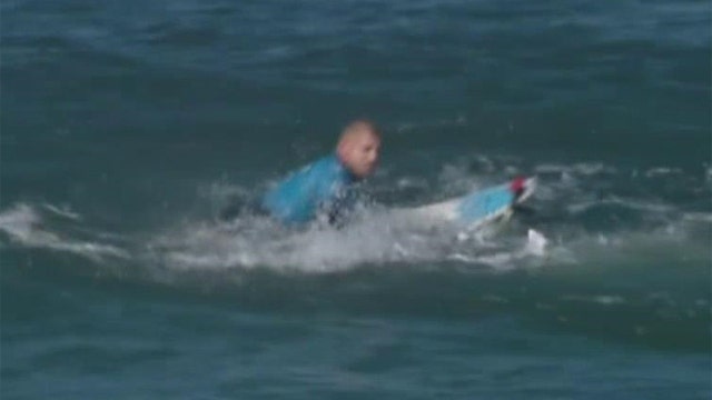 Surfing champ fights off shark attack on live TV