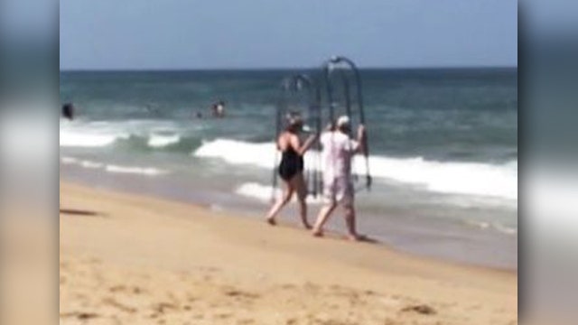 Couple takes homemade shark cages for a dip