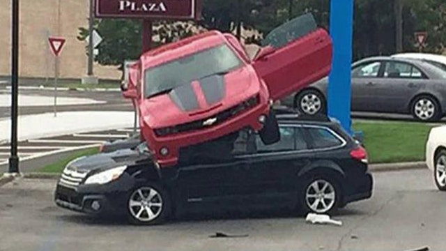 Crazy crash: Camaro goes airborne, lands atop another car