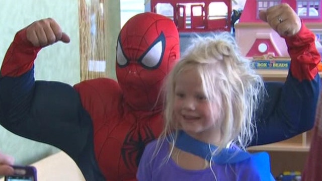 Superheroes bring smiles to children's hospital