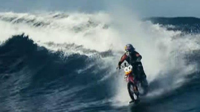 Pipe dream: Daredevil rides the waves on his motorbike