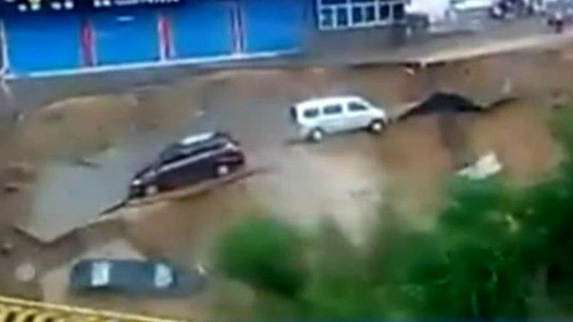Road rips apart, cars plummet into muddy waters
