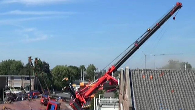 Cranes collapse into row of homes injuring at least 20