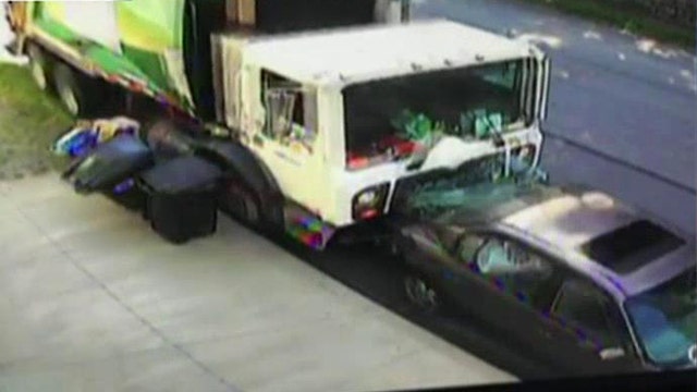 Runaway garbage truck smashes into parked cars
