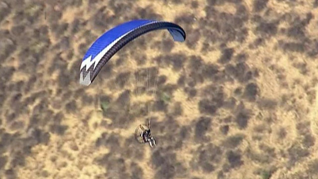 Slow-speed sky chase after paraglider flies over jail