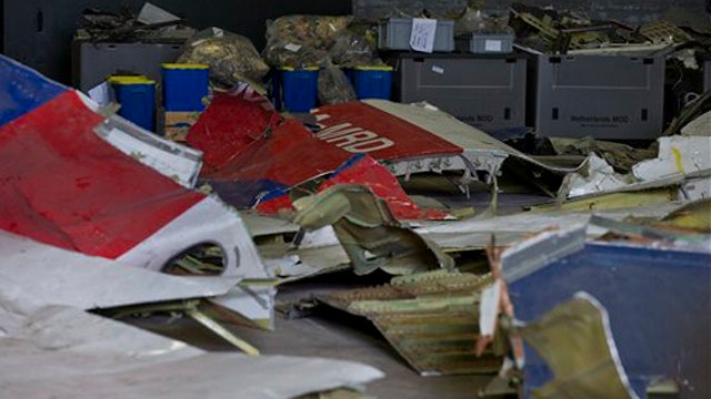 Dutch team examine possible missile parts at MH17 crash site