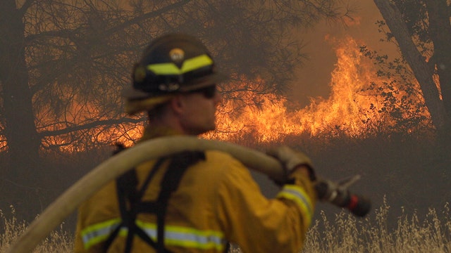 Hundreds of firefighters battle blazes across West Coast