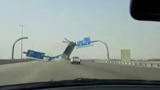 Dump truck slams into highway sign, demolishes it