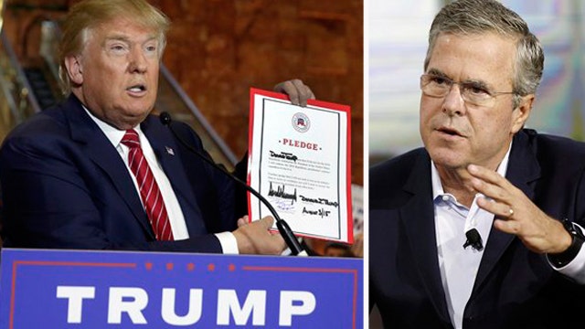 Trump signs RNC pledge amid feud with Bush