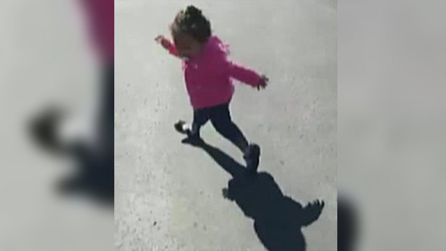 Little girl tries to run from her own shadow