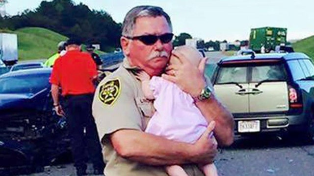 Sherriff’s deputy comforts baby after car crash