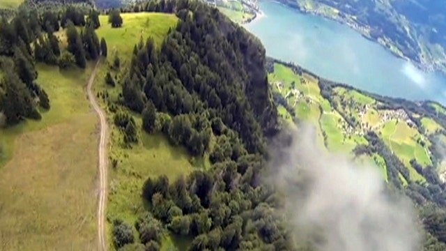 Wingsuit daredevil dives through alpine ravine