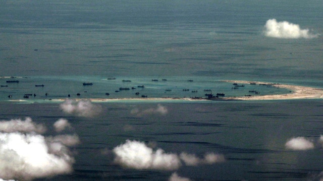 China warns US after Navy ship passes disputed islands